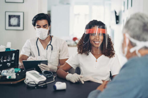 Doctors visiting a senior patient at home