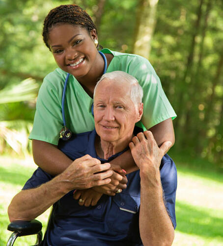 Senior man enjoying a hug from his caregiver.